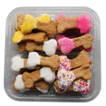 Assorted dog treats in the shape of bones with different toppings in a clear container.