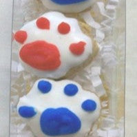 dog treats with red, white, and blue paw prints on a clear background